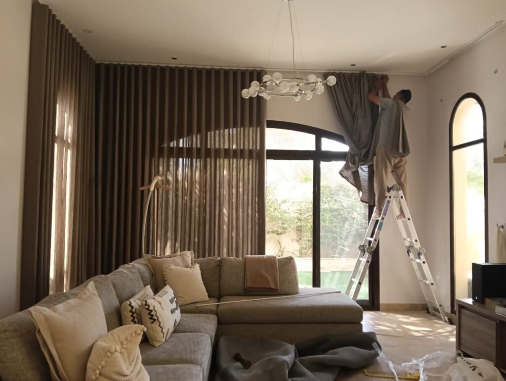  Roller blinds vs curtains comparison in a Business Bay living room window
