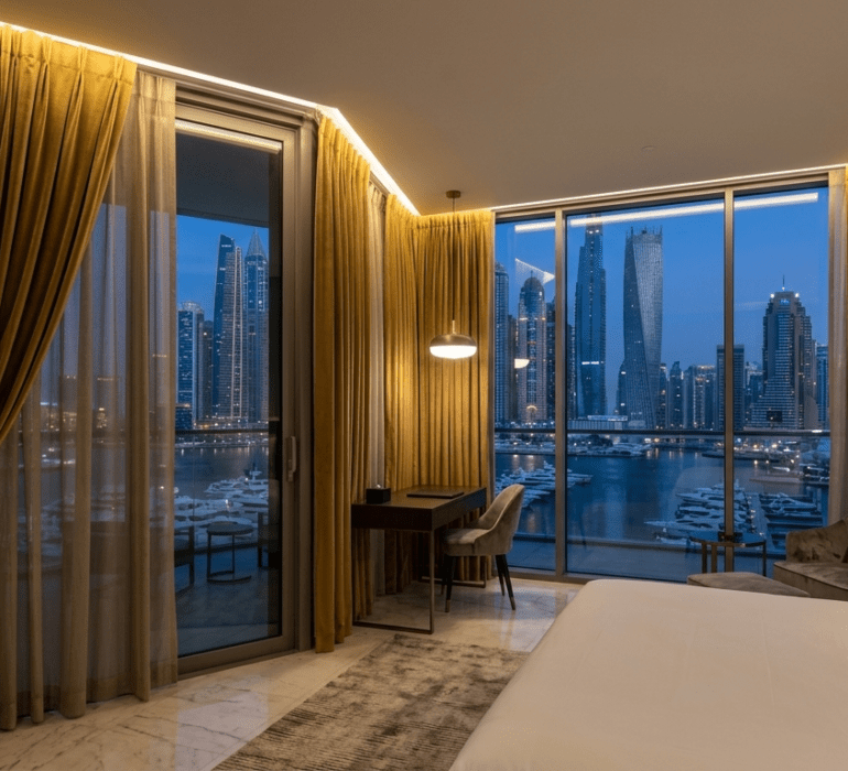 Luxury motorized blackout curtains in a Dubai hotel suite overlooking Dubai Marina